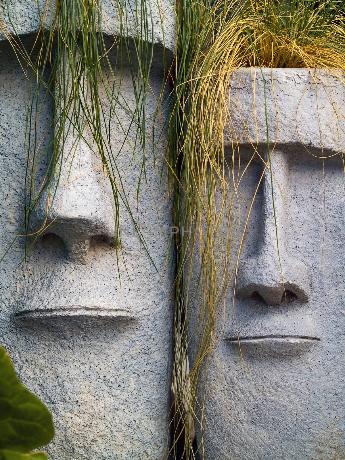 Easter Island planters with long grean and yellow grass hair