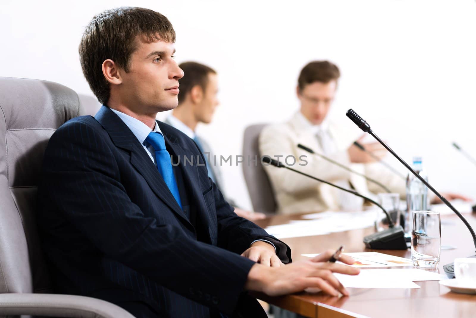 Portrait of a businessman, in the background colleagues communicate with each other