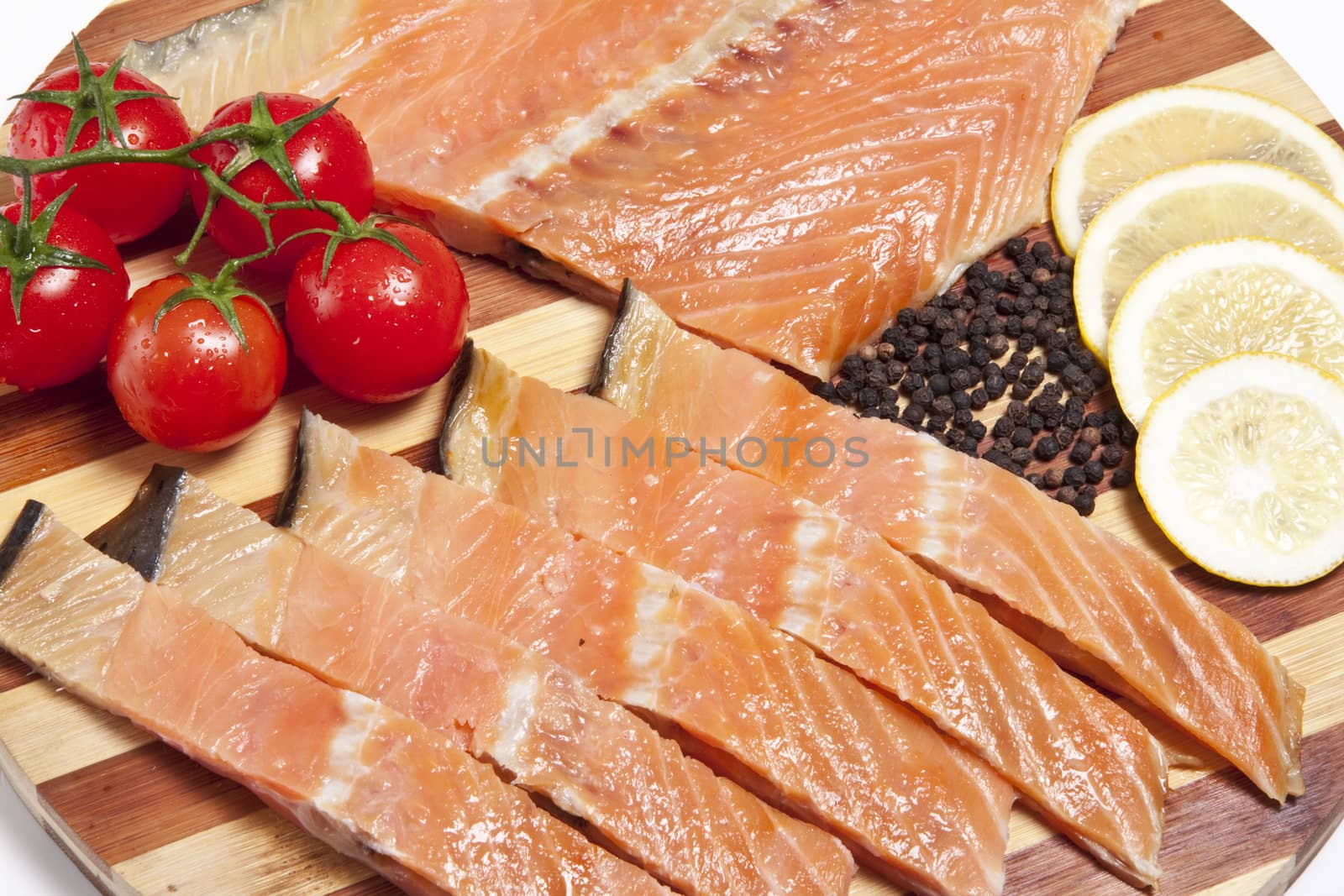 close-up of smoked salmon  with tomato and lemon