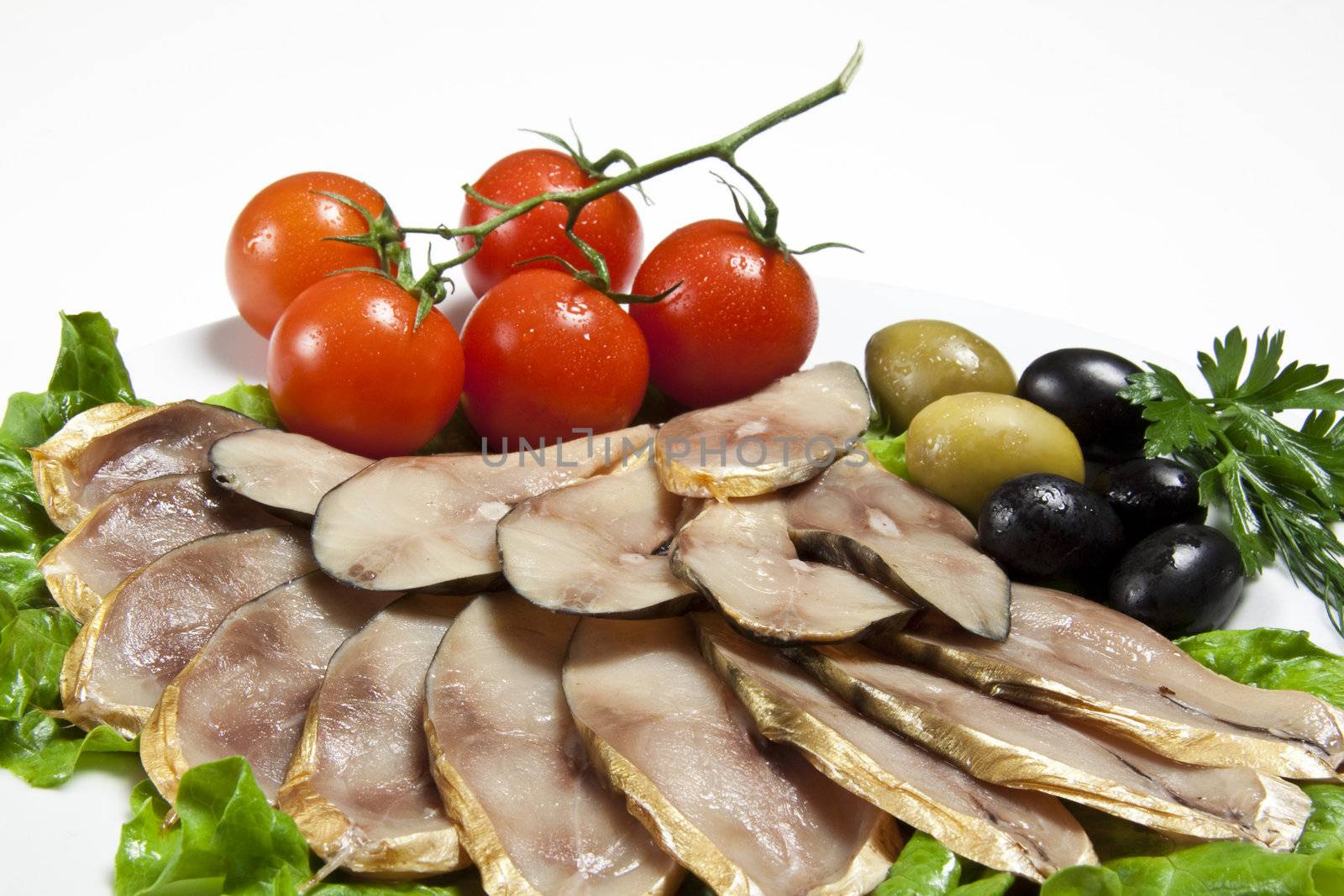 slices smoked fish served with tomato and olive