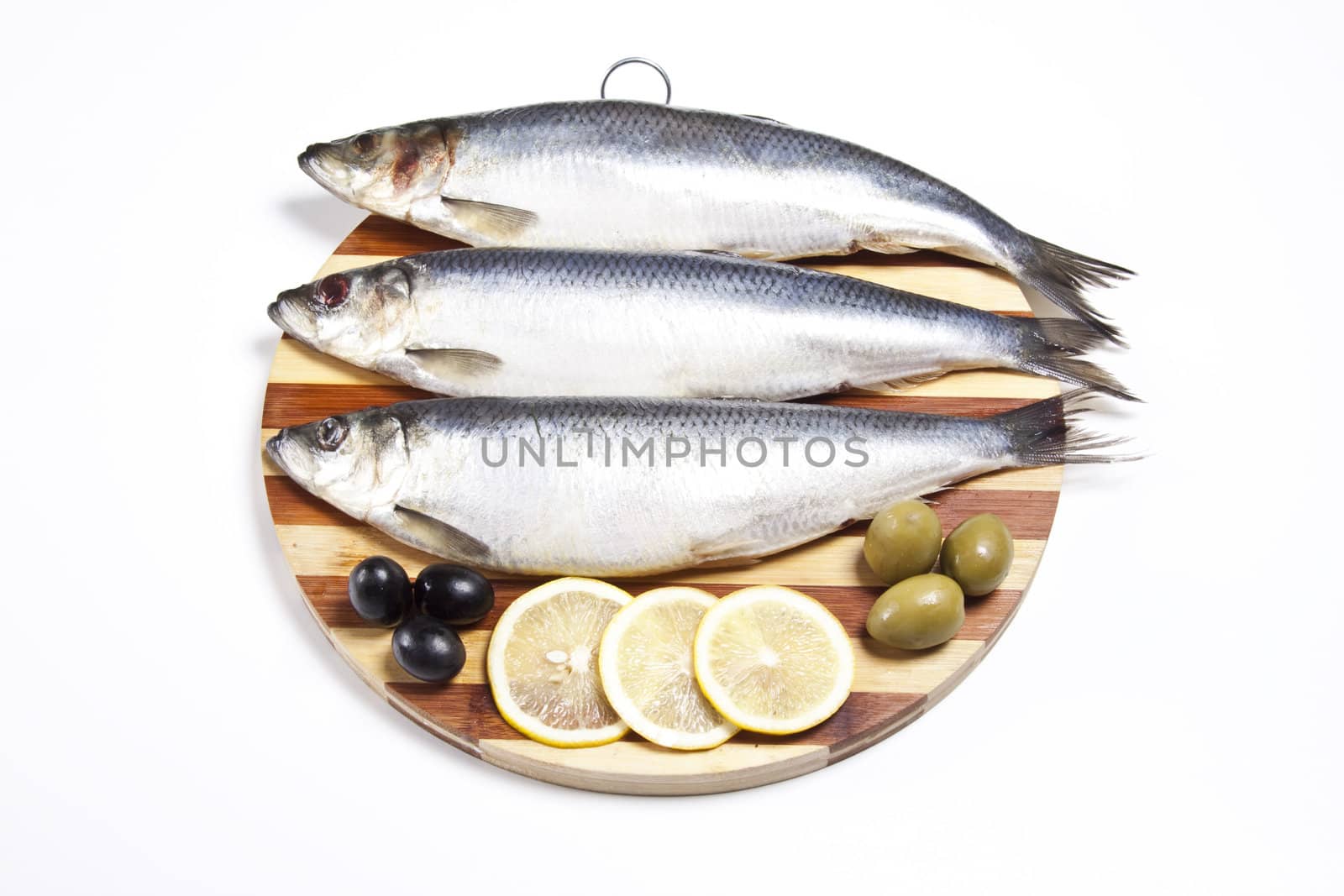 Fish with lemon and olive on plate