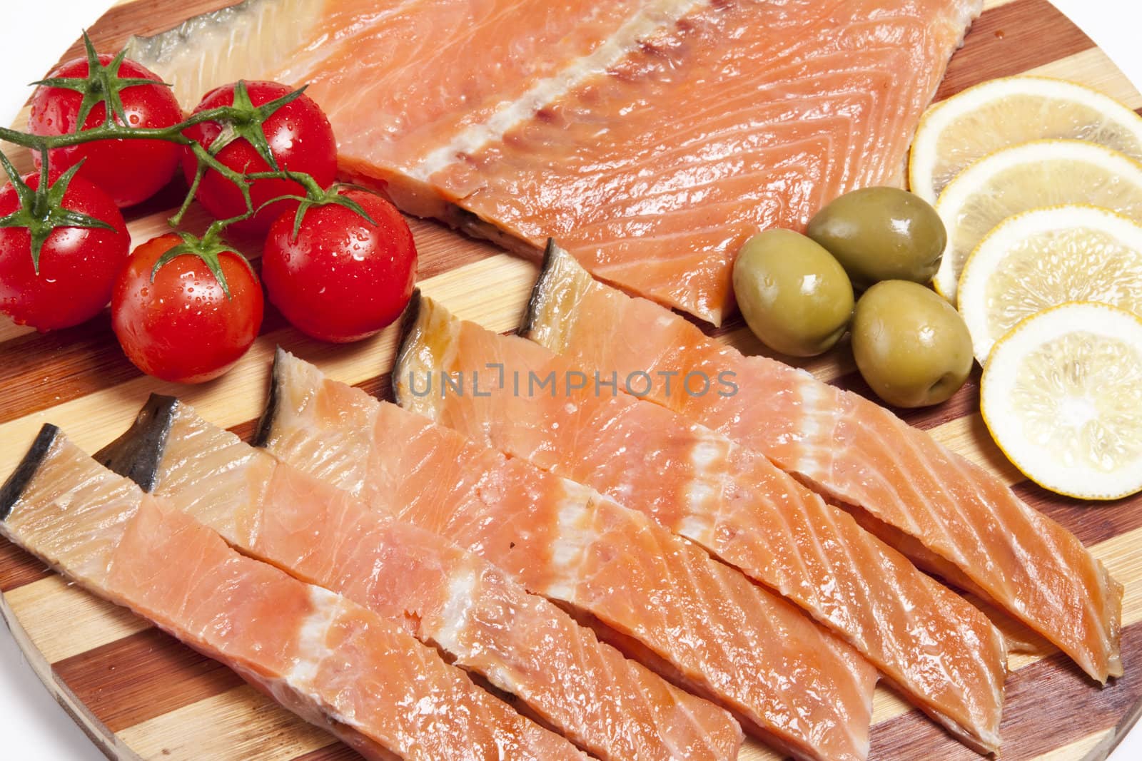 close-up of smoked salmon on wooden plate