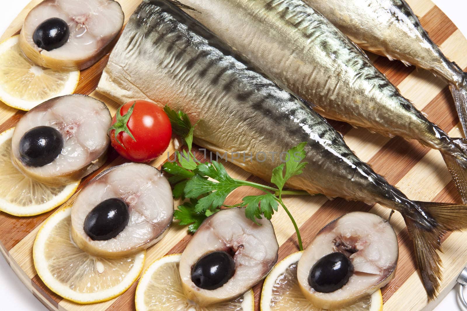Dish with the cut smoked mackerel with olives