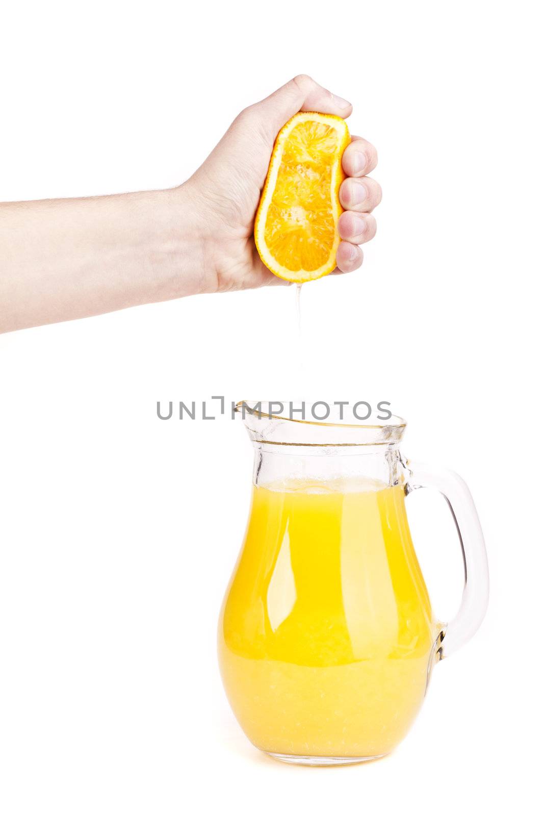 hand pour orange juice from orange