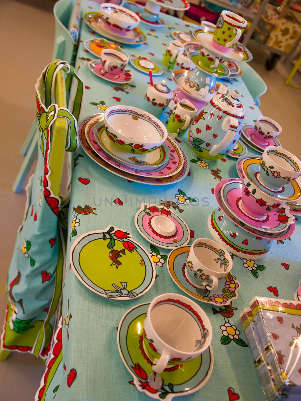 Country style dining room table arranged with traditional hand painted dishes