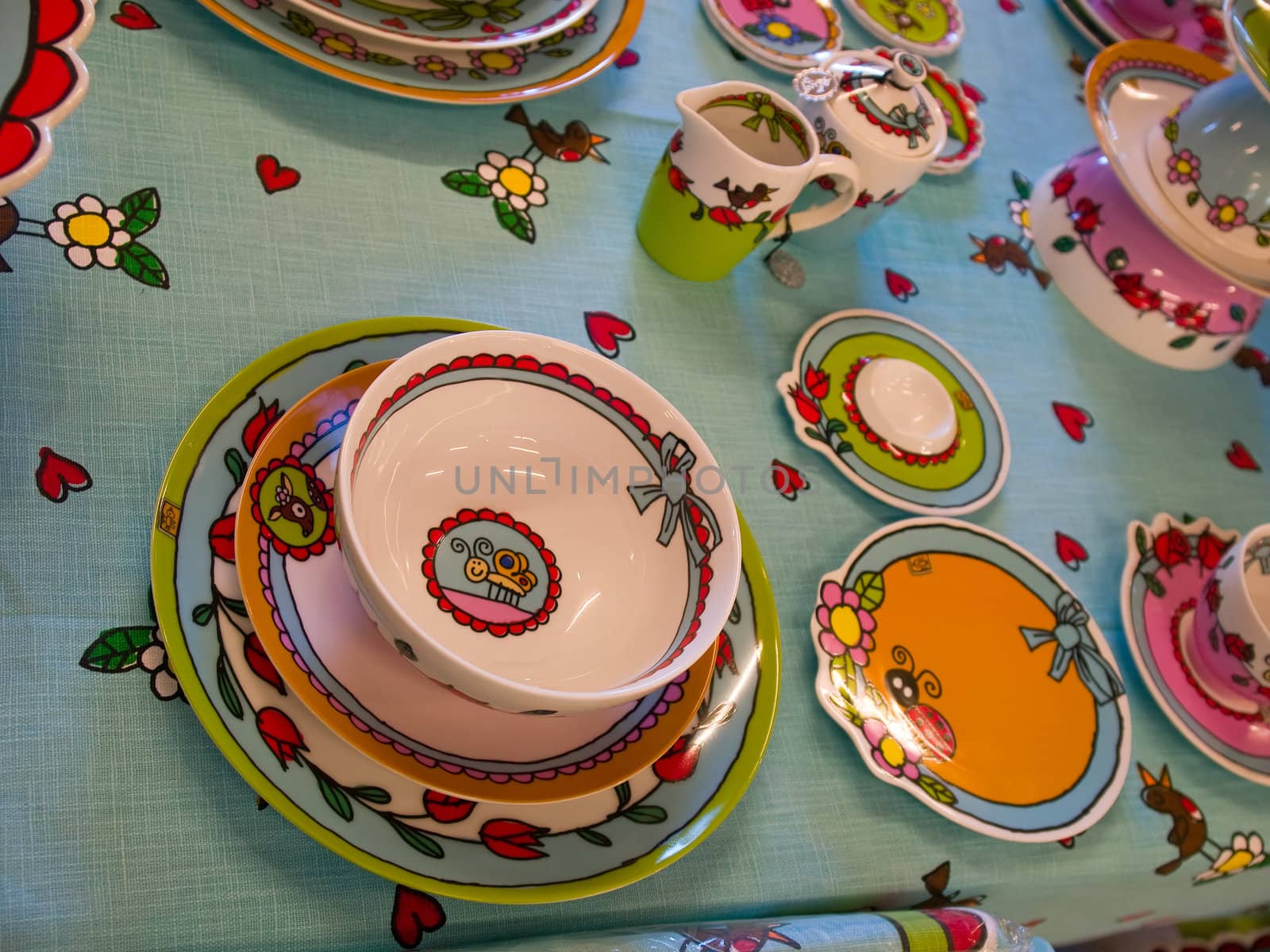 Country style dining room table arranged with traditional hand painted dishes
