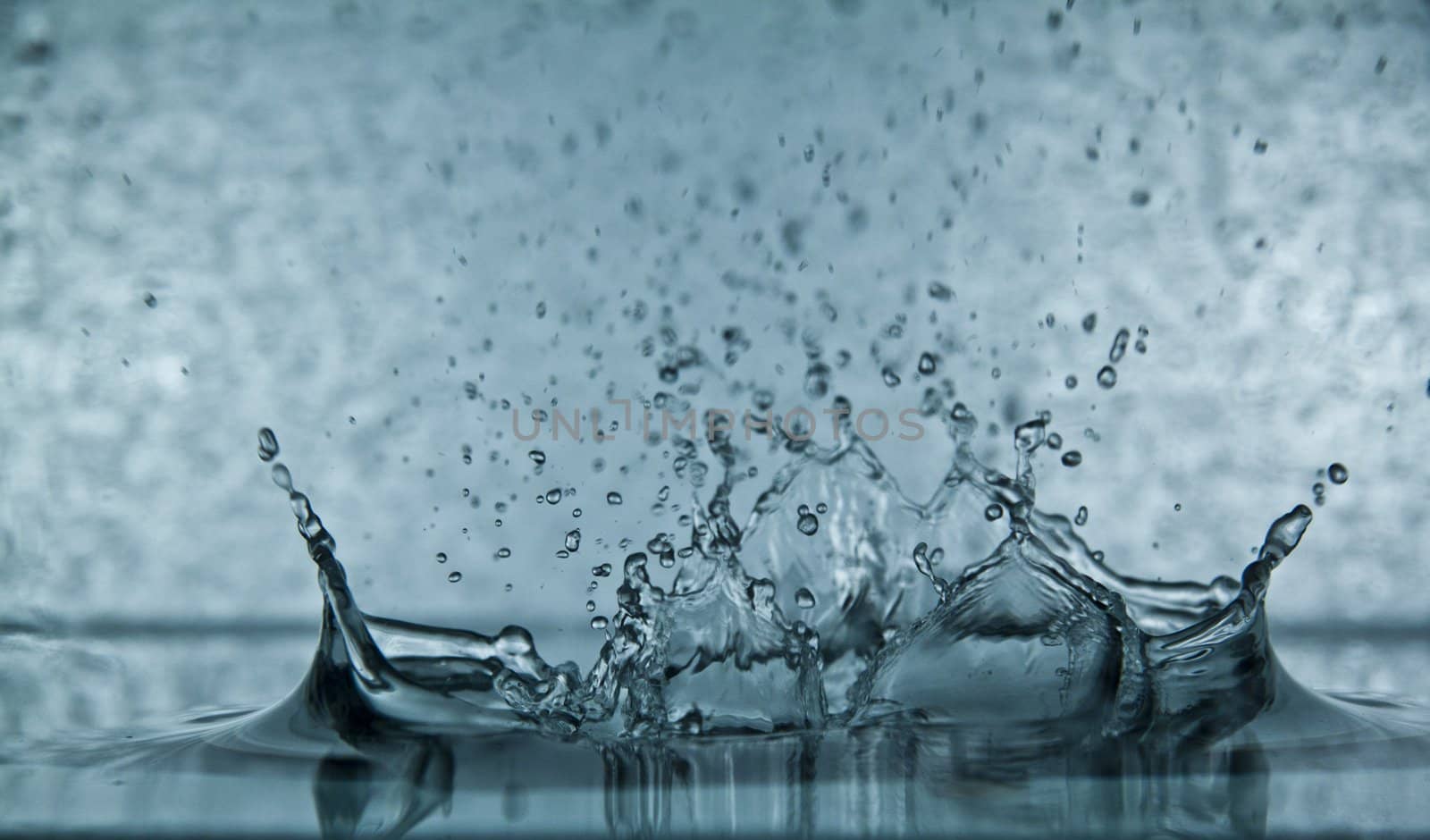 Sparks of blue water on a gray background