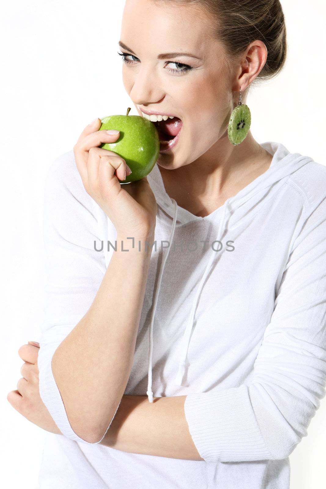 Girl with a green apple on a white background by robert_przybysz