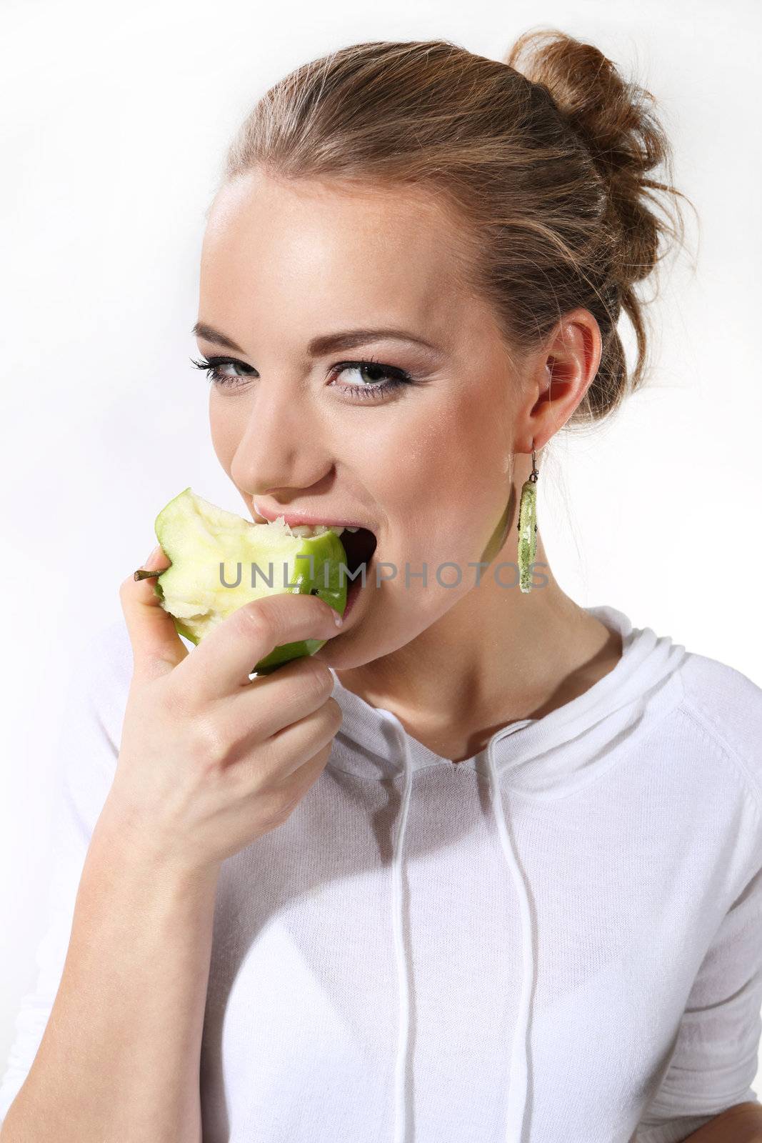 Girl with a green apple on a white background by robert_przybysz