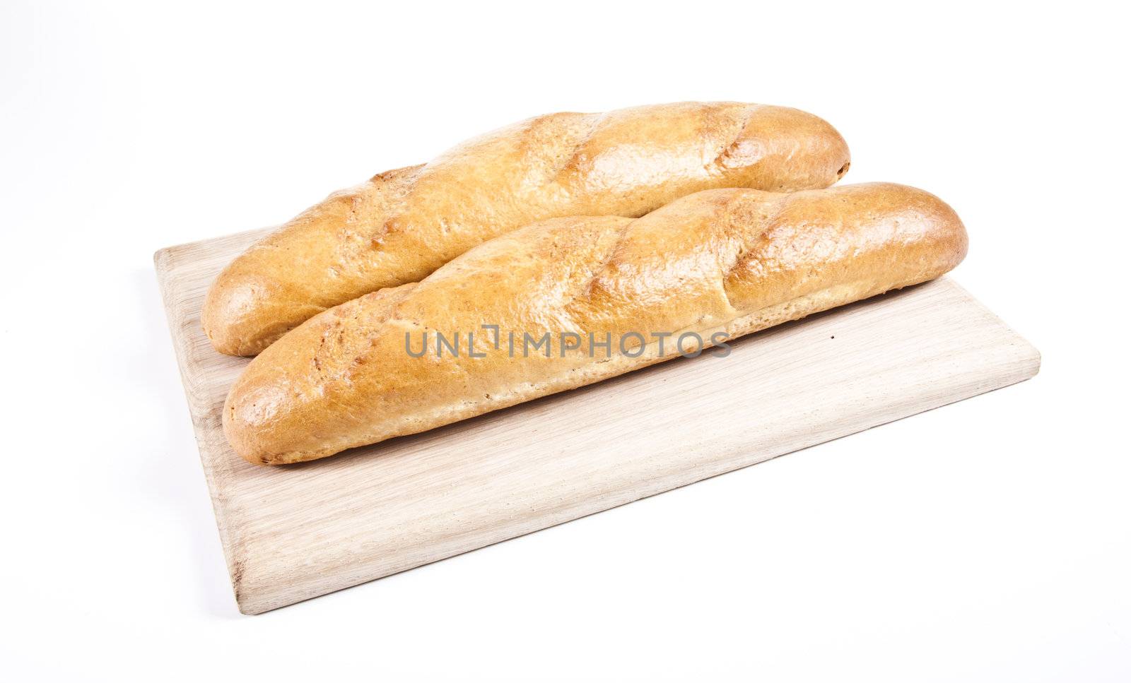 fresh baguette on wooden plate