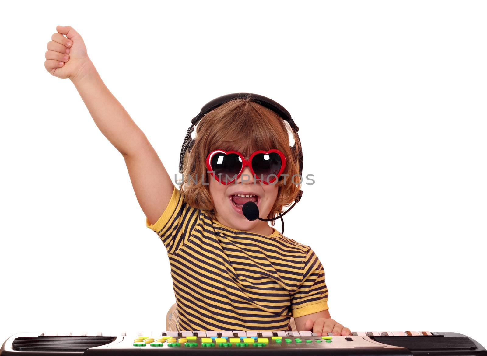 happy little girl play keyboard and sing