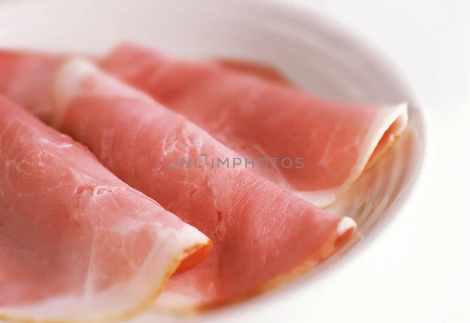 smoked meat slices on a white plate