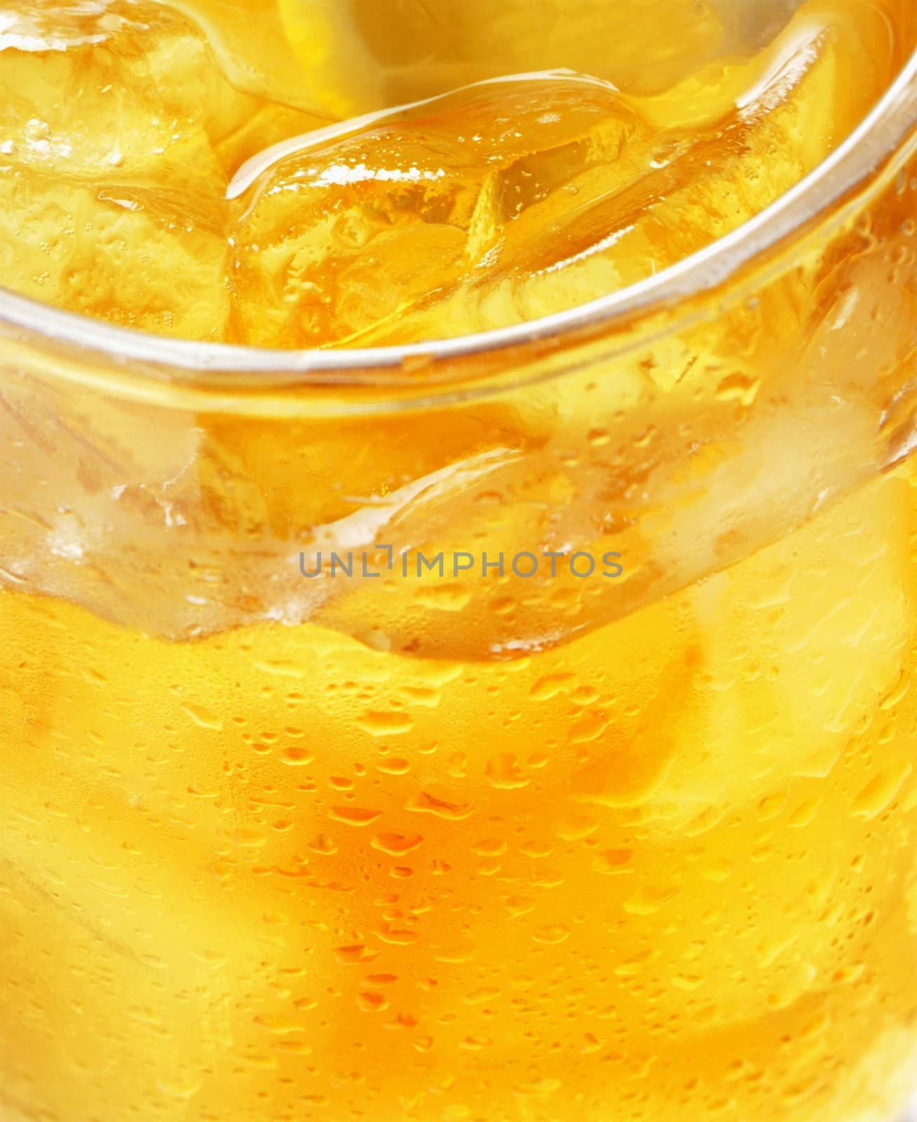 glass of orange juice with ice - macro