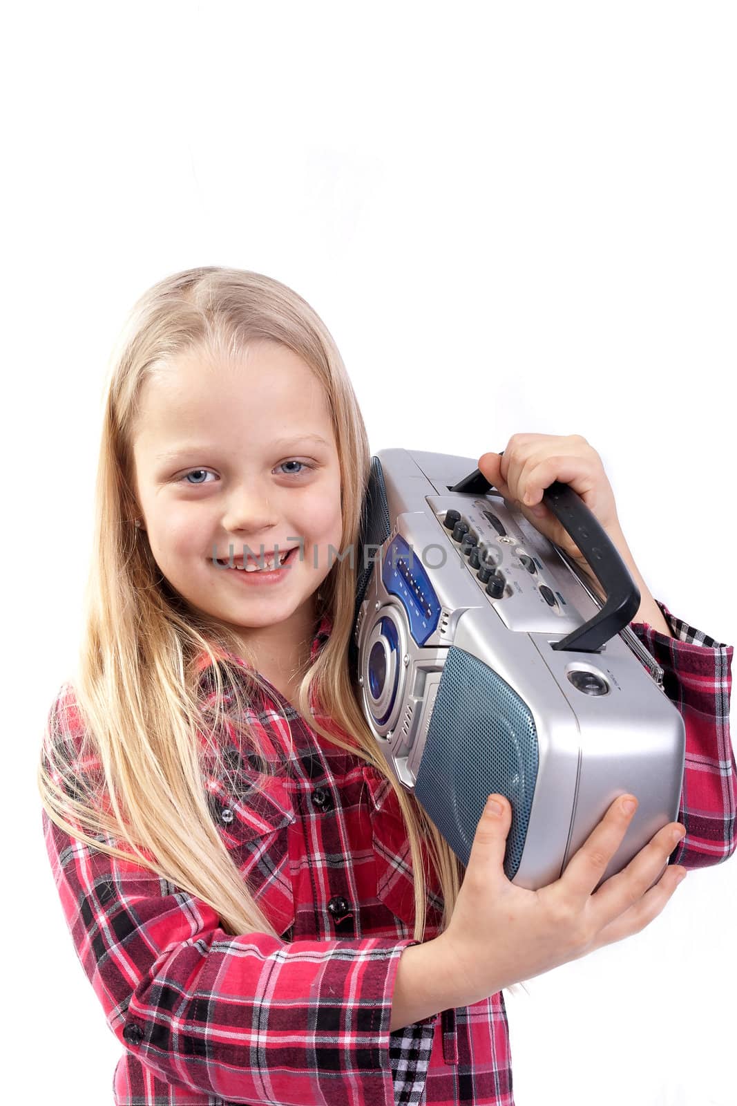 pretty little girl listening music and holding portable CD radio