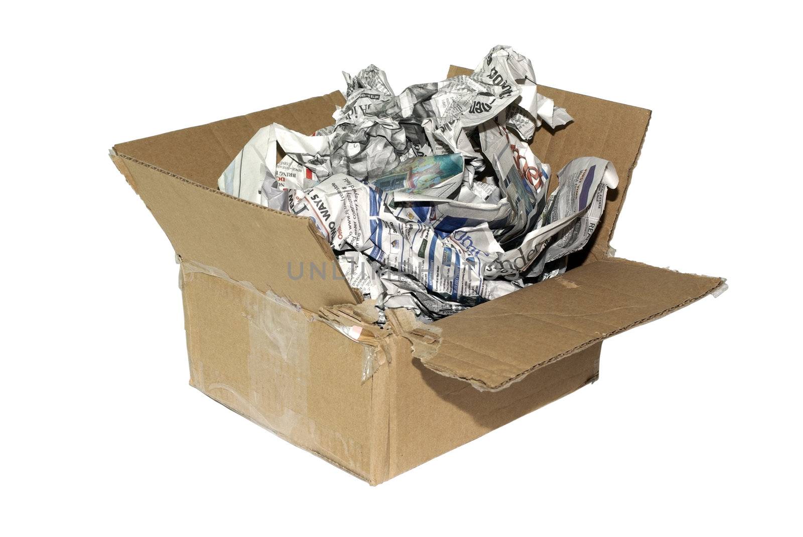 Cheap variation of package for fragile item. Cardboard box with newspapers isolated on white background.