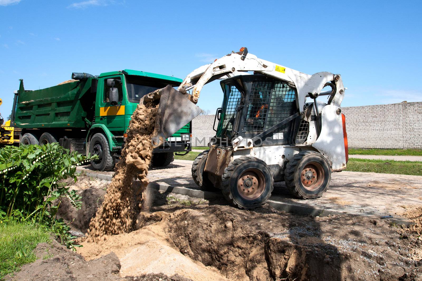Mini Bobcat work on a street reconstruction