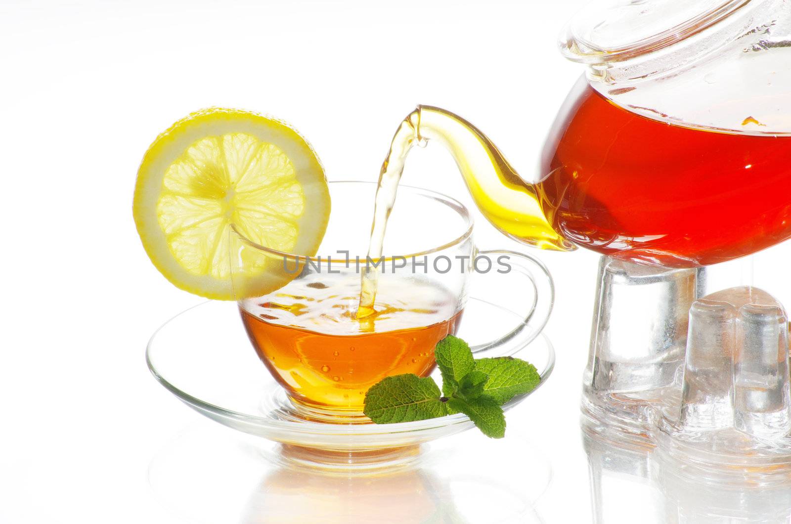 tea being poured into glass tea cup