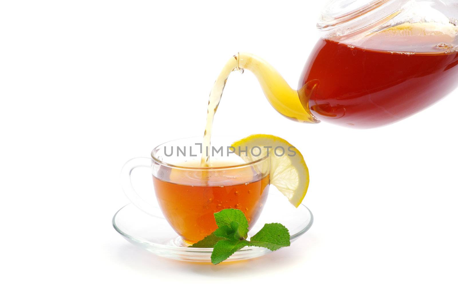 tea being poured into glass tea cup