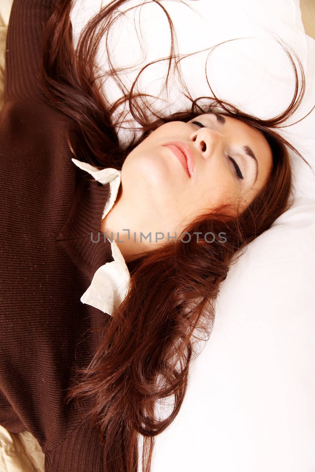 A sleeping young woman in bed.