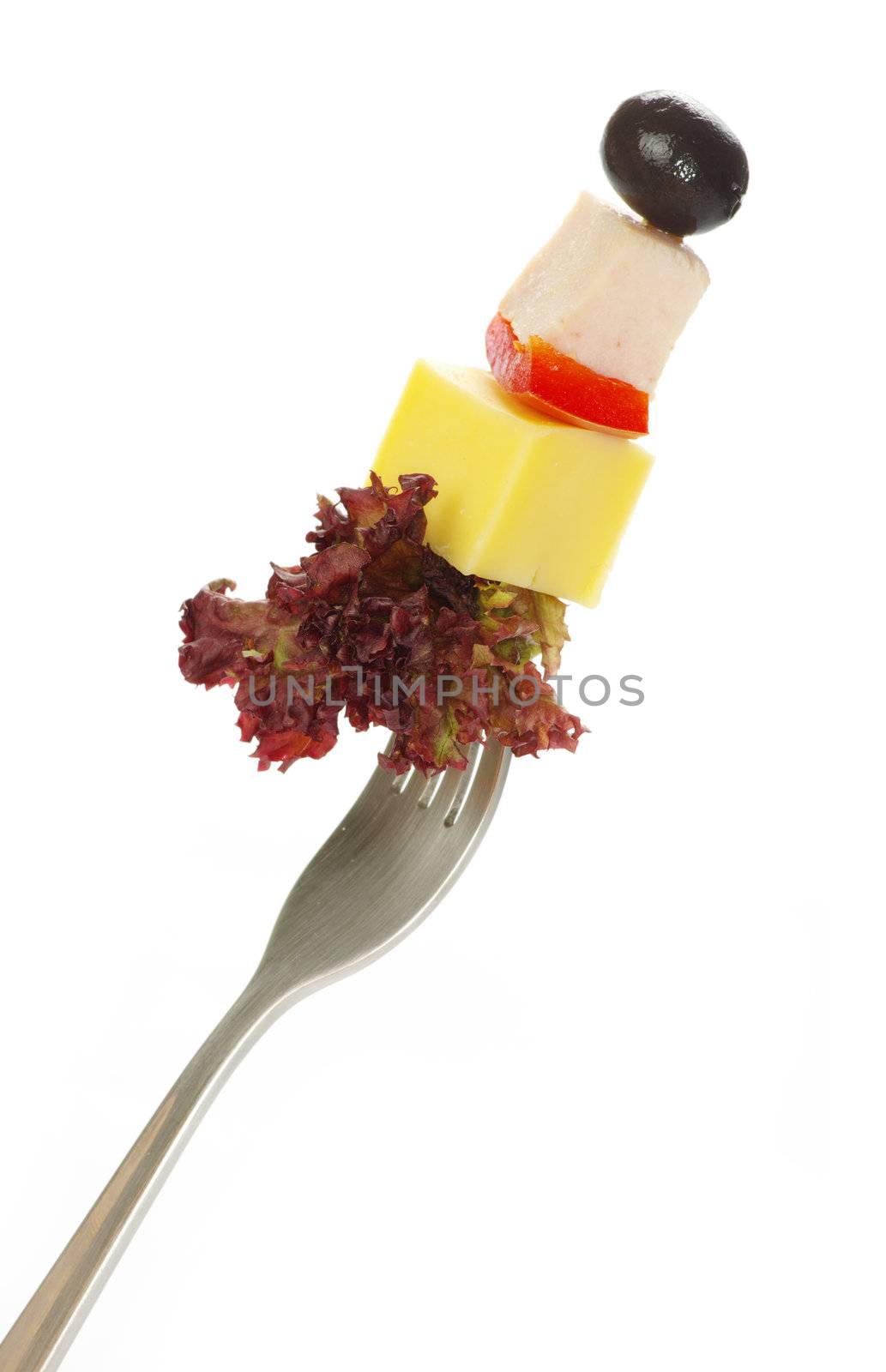 Fresh vegetables on a fork isolated on white background