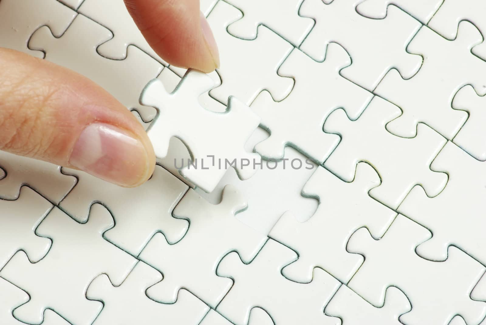 hands holding a puzzle piece . business concepts