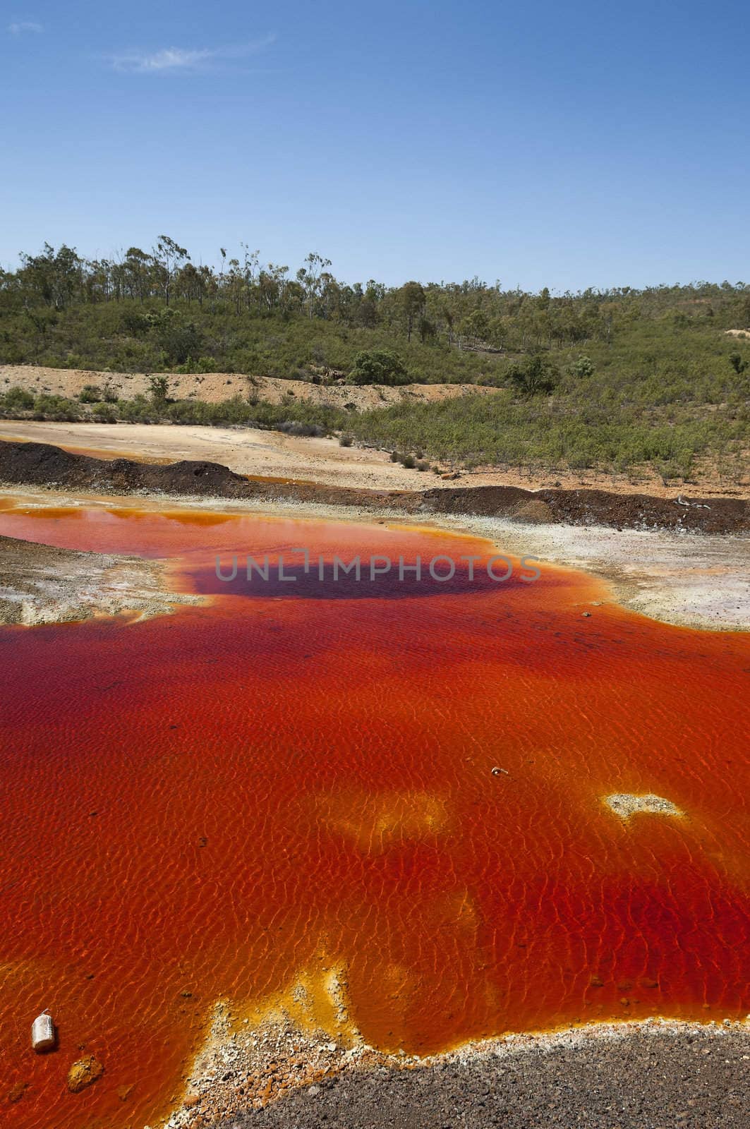 Detail of the red acid water pond in São Domingos Mine, a deserted open-pit mine in Mertola, Alentejo, Portugal. This site is one of the volcanogenic massive sulfide ore deposits in the Iberian Pyrite Belt, which extends from the southern Portugal into Spain