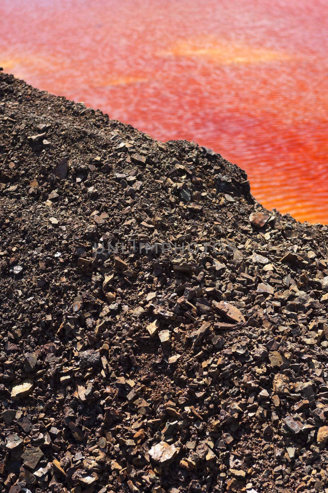 Detail of the red acid water pond in São Domingos Mine, a deserted open-pit mine in Mertola, Alentejo, Portugal. This site is one of the volcanogenic massive sulfide ore deposits in the Iberian Pyrite Belt, which extends from the southern Portugal into Spain