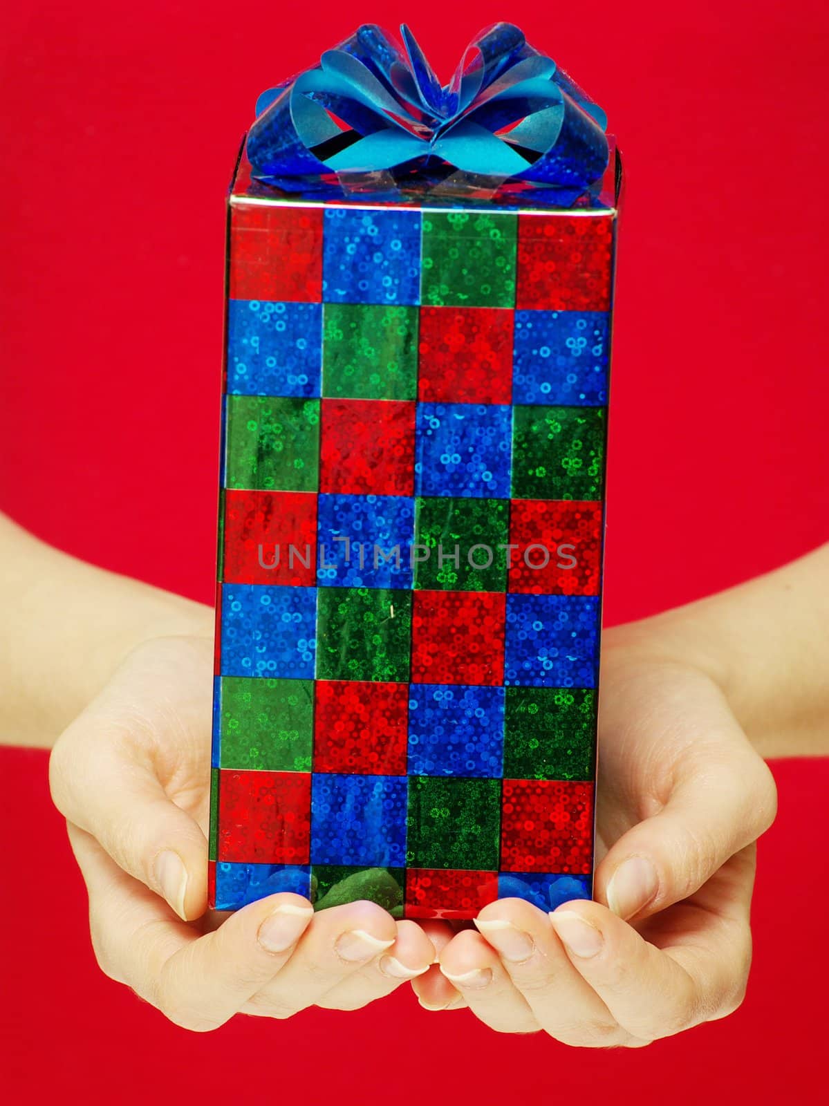 christmas gift in hands isolated on red 