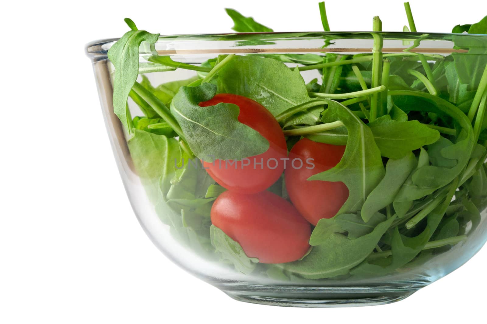 Salad with rugola and cherry tomato in glass bowl (side) with clipping path