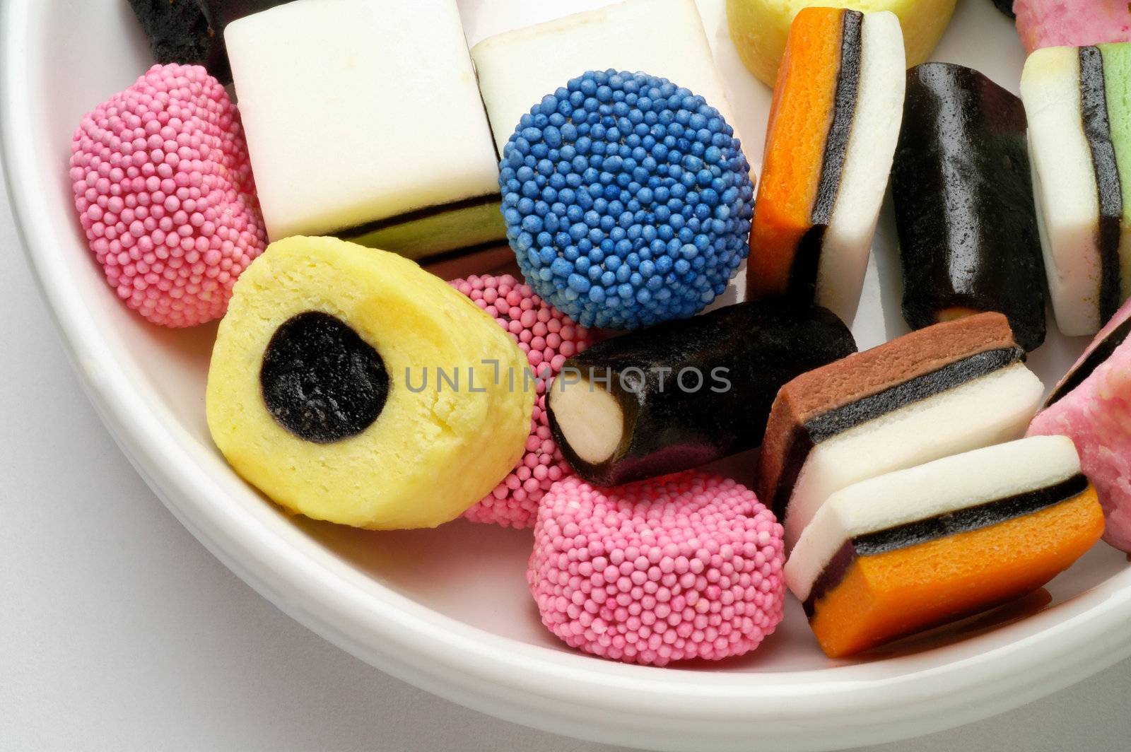Licorice candies in bowl by Laborer