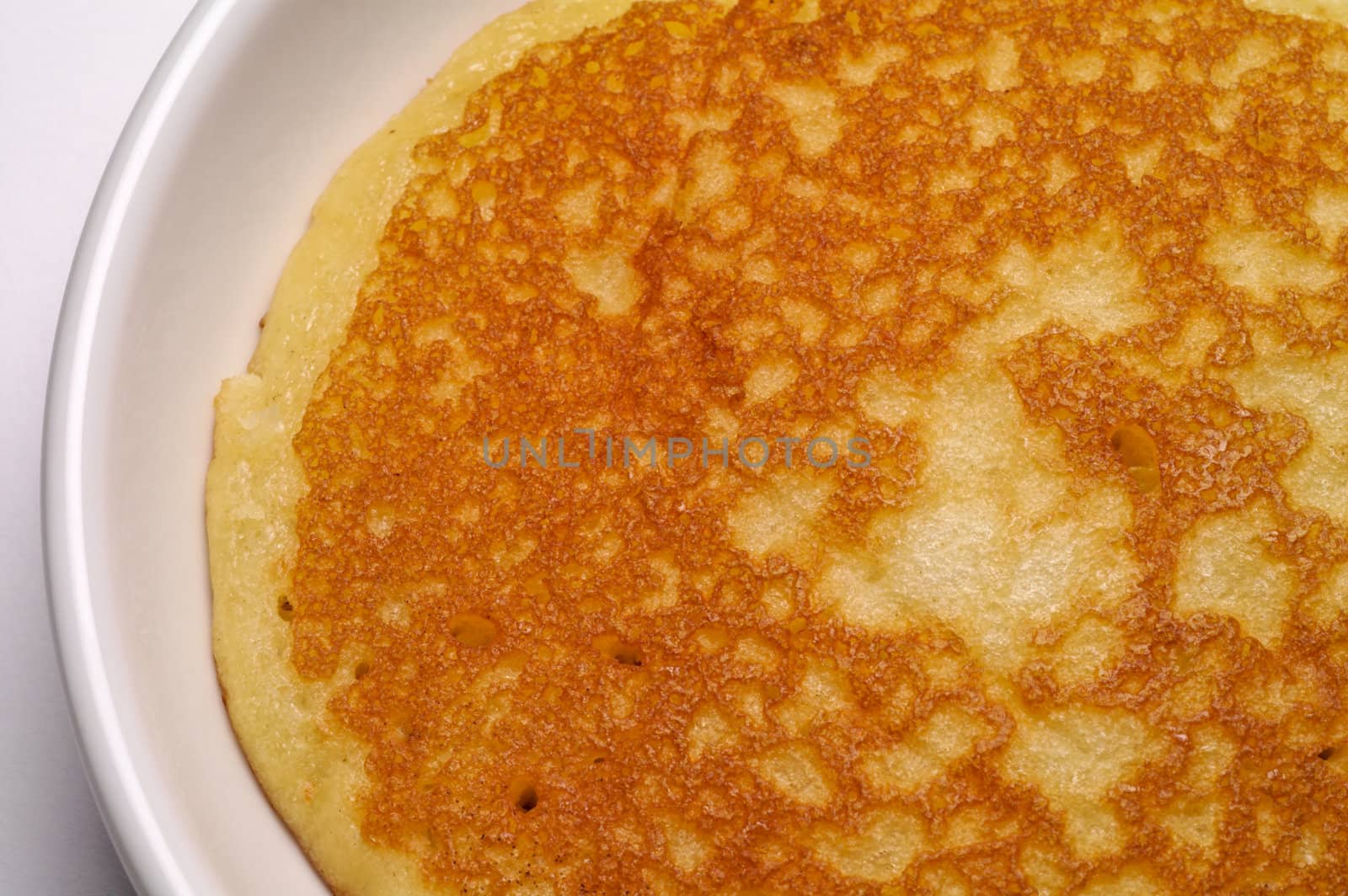 Pancake in a dish on white background