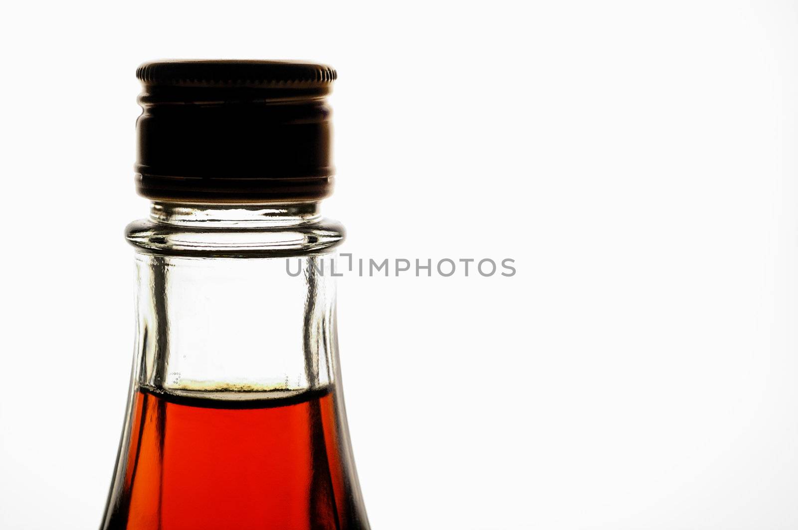 Bottle with maple sirup back lighted horizontal). Can be wine, liquor, etc.