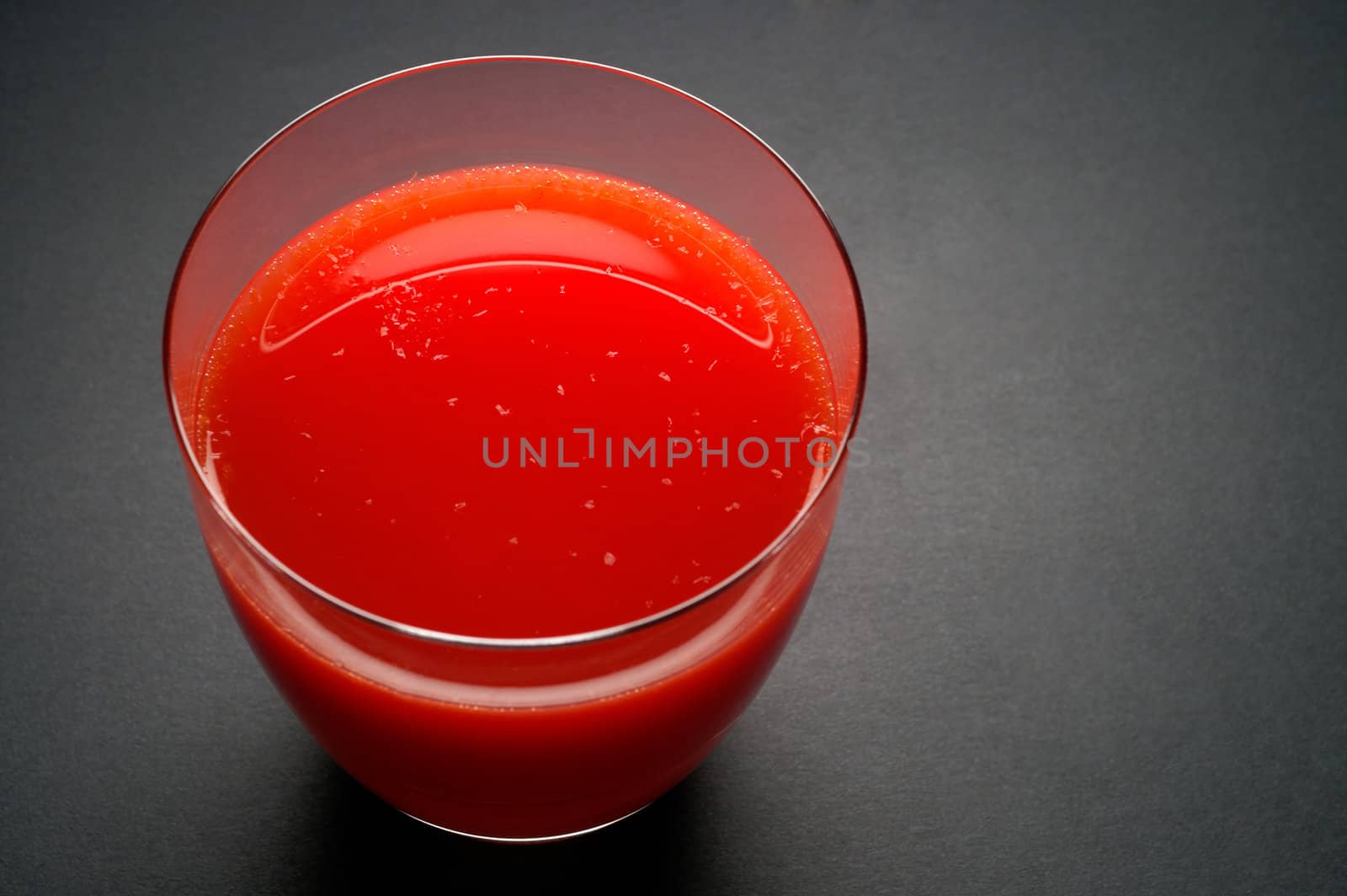 Glass with red orange juice by Laborer