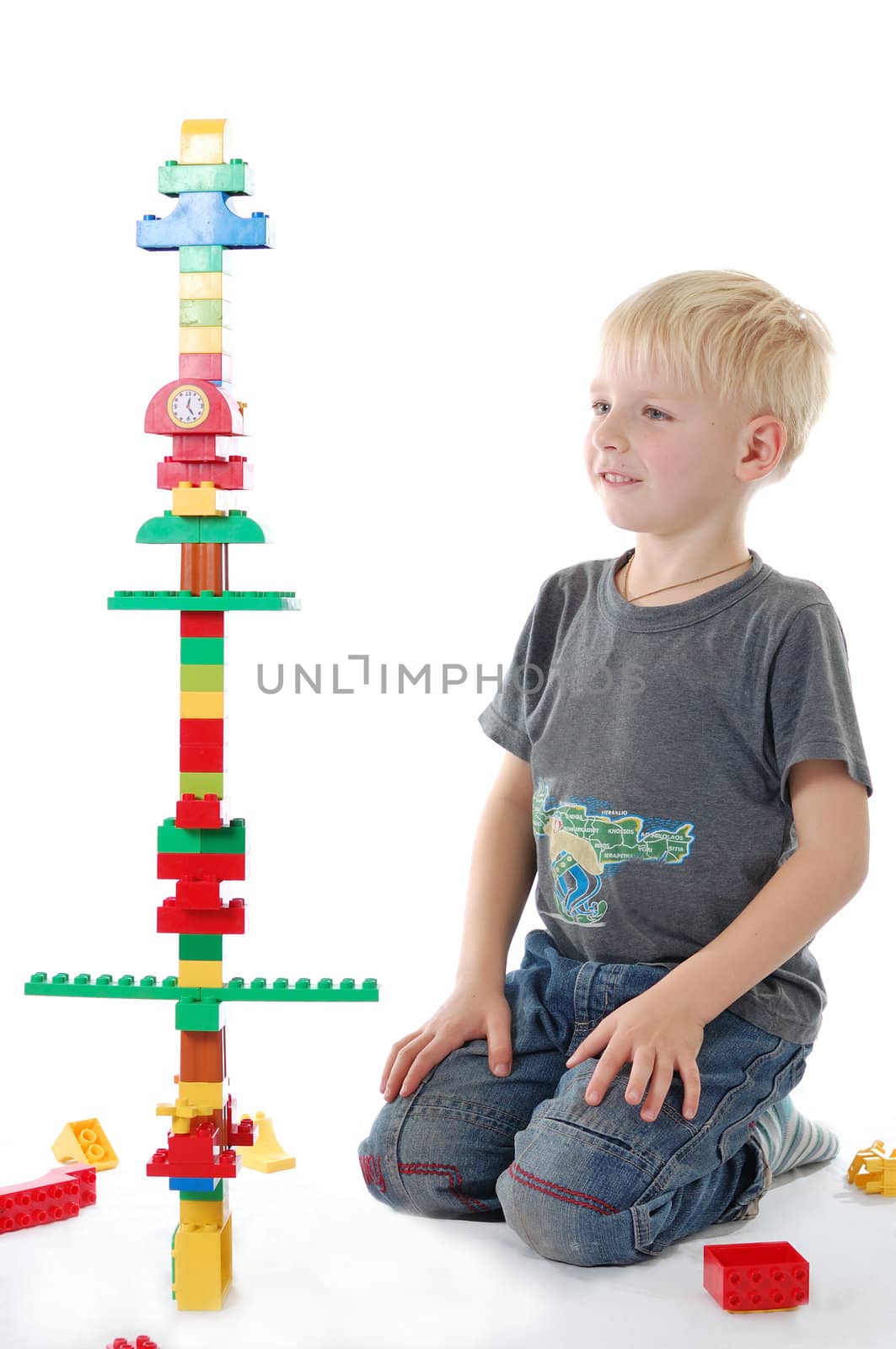 Little boy and his hand-made clock tower.