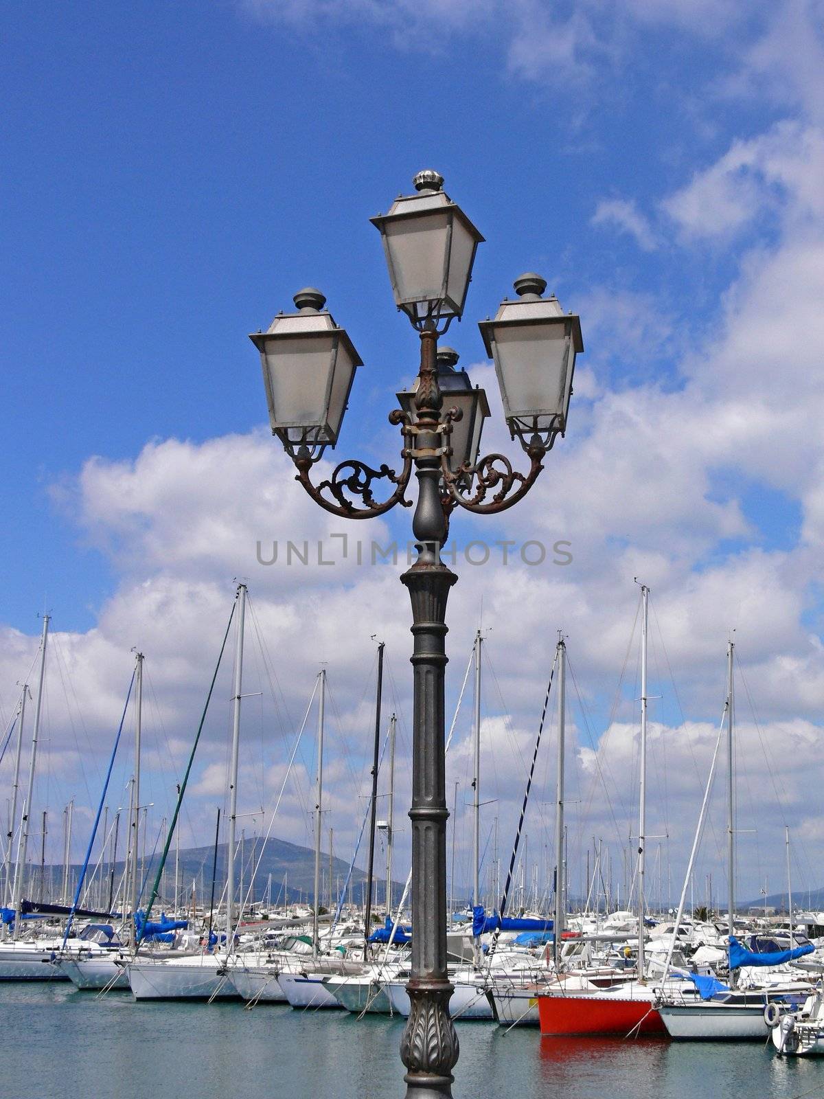 Alghero, lantern at the port, Sardinia. by Natureandmore