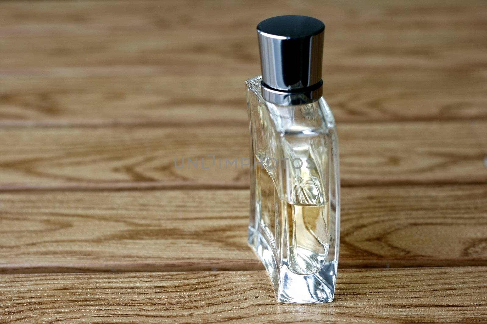 Mens Perfume and Fragrance in a wooden tile background