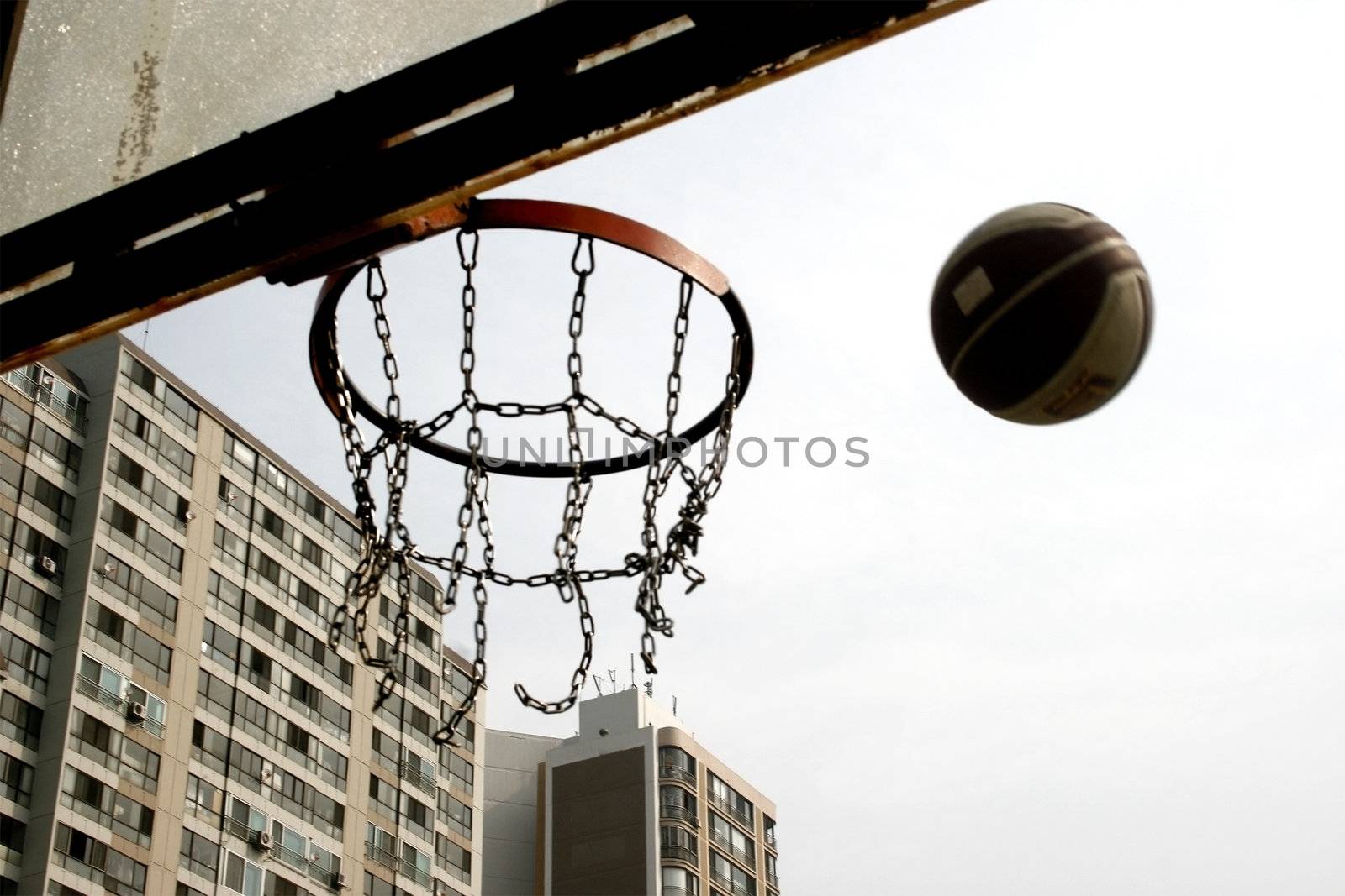 The ball is shoot on a metal chain hoop- ball in motion