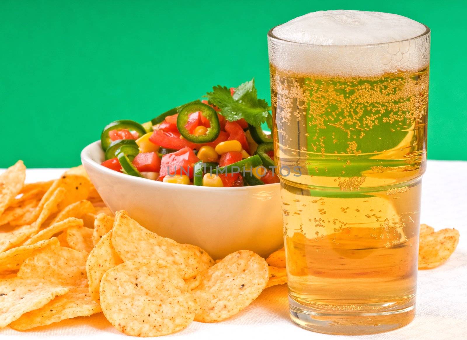 Cold beer and spicy salsa with corn chips.