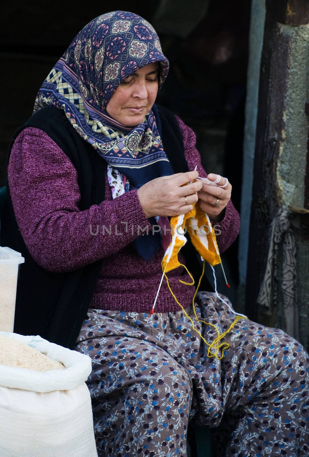 April 2008 Ankara Turkey - traditional Turkish woman knitting out in the street