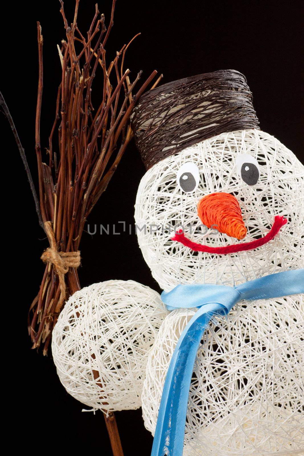 A snowman made of thread over black background