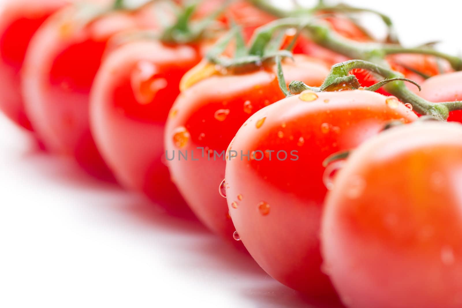 Some fresh ripe cherry tomatoes on a branch