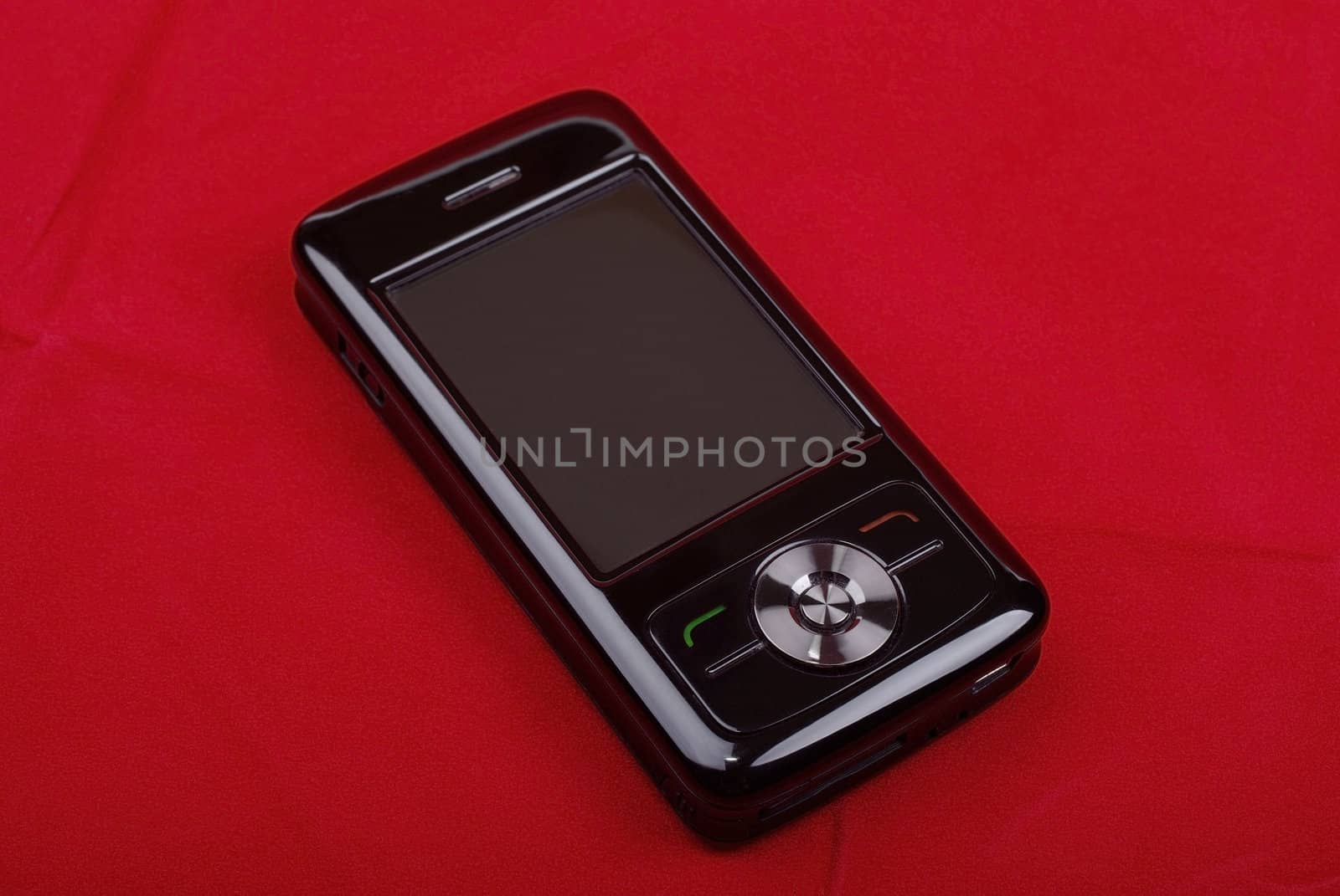 Black luxury pda phone isolated on red background. by borodaev