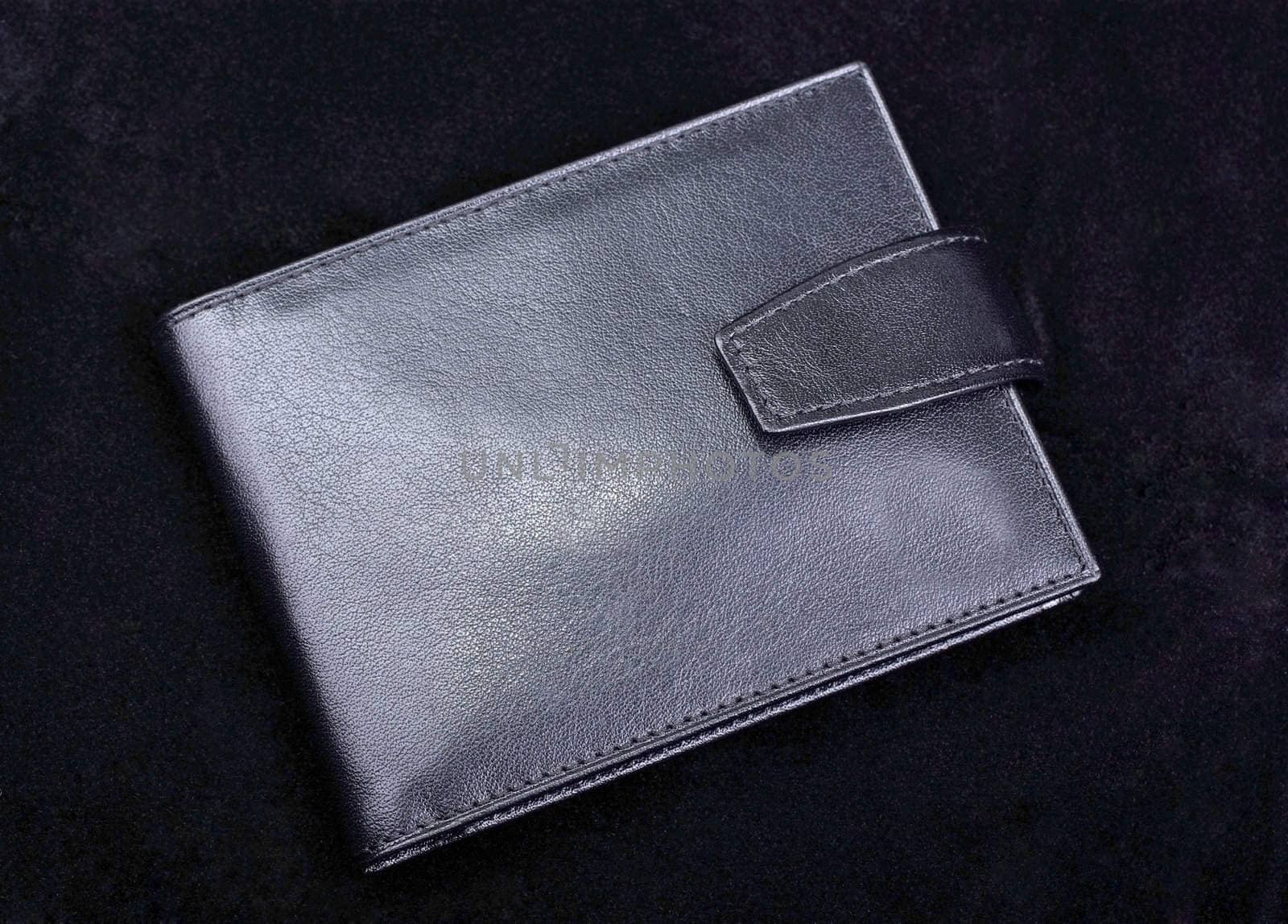 High quality leather wallet isolated on black velvet background. Studio shot.
