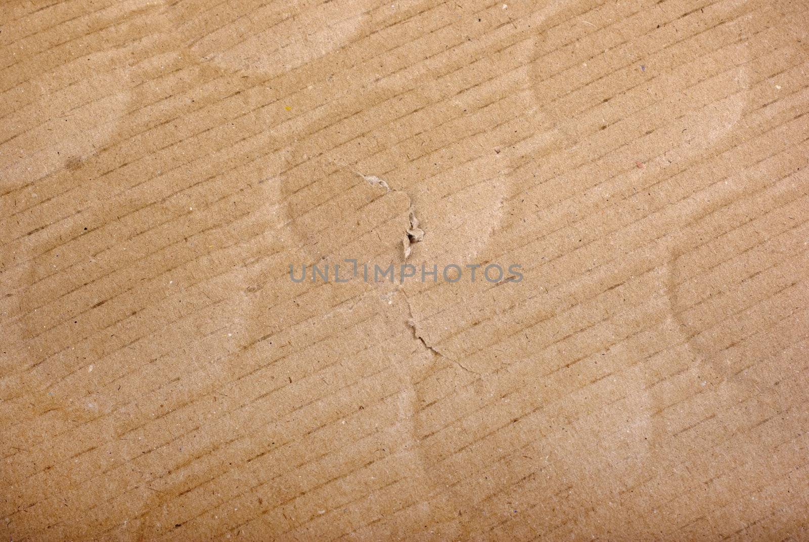 Brown damaged cardboard with bottle traces as background.