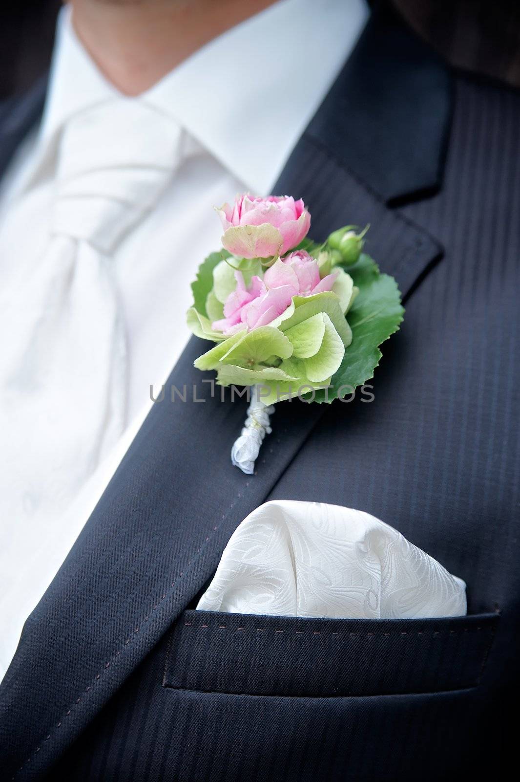 Flower on a tux of a groom with shallow depth of field