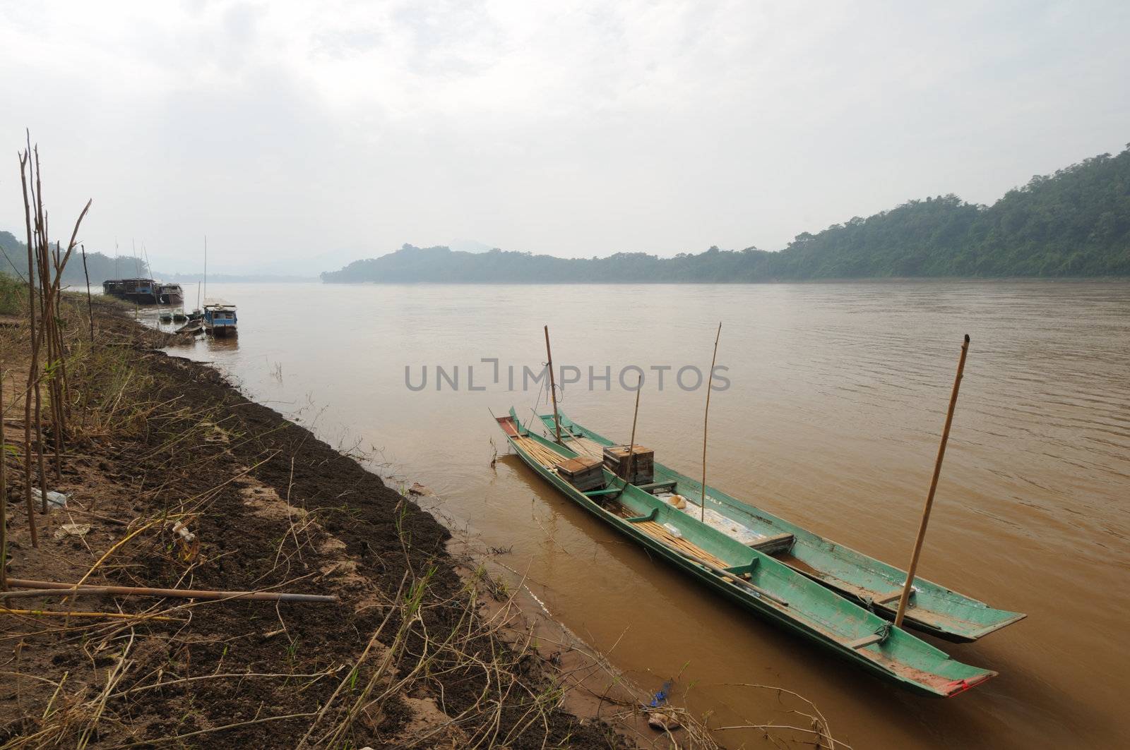 Wooden long tail boats at Mekong river in Luang Phabang, Laos.