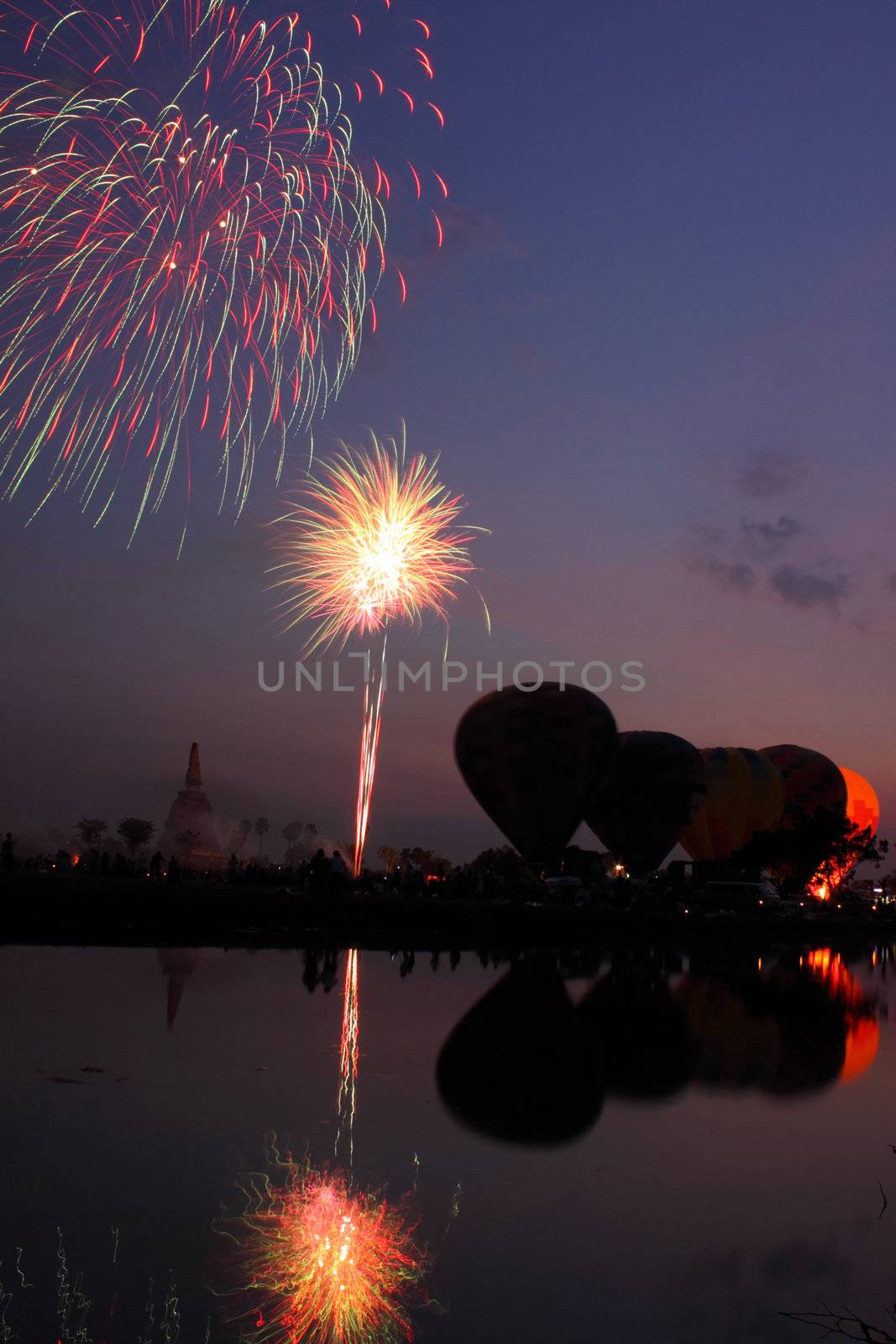 Fireworks show and balloons in the night at Thailand. International Balloon Festival.