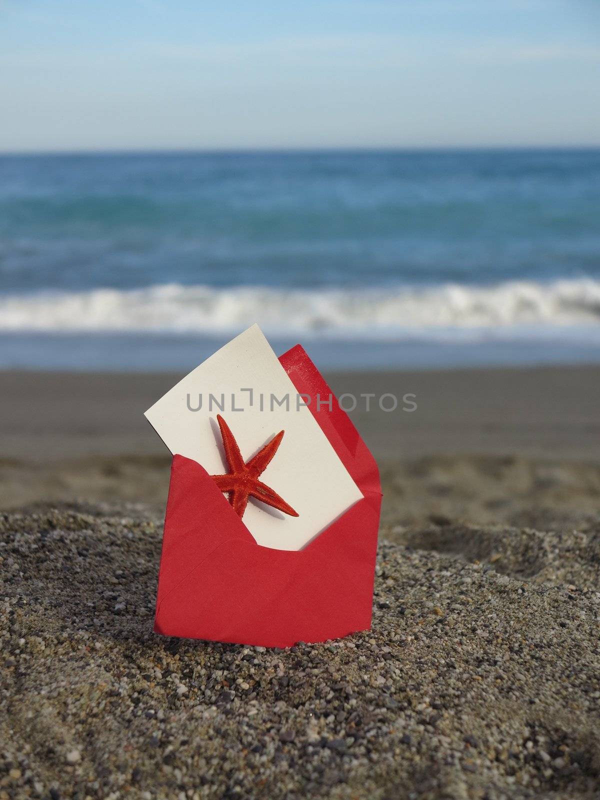 Decorative red  envelope on sand background