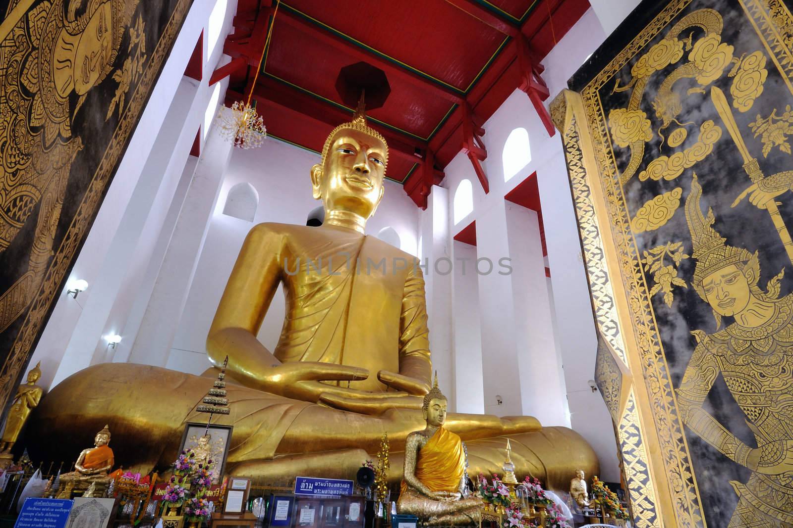 Big gold statue Buddha in cathedral Thai temple. by ngungfoto