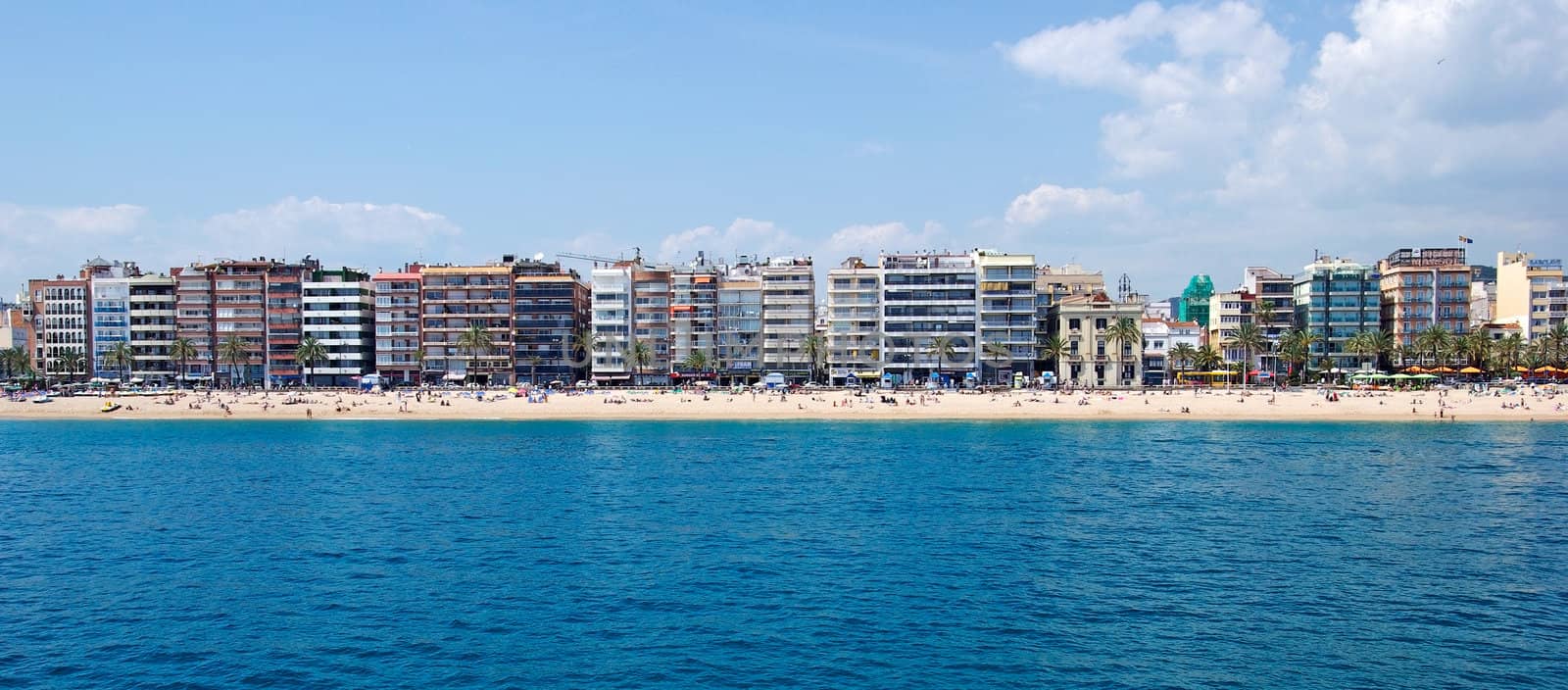 Panoramic cityscape of Lloret de Mar from sea, Costa Brava, Spai by borodaev